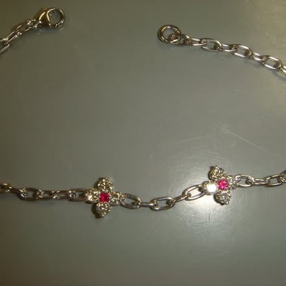 Gold chain bracelet with ruby flower stations