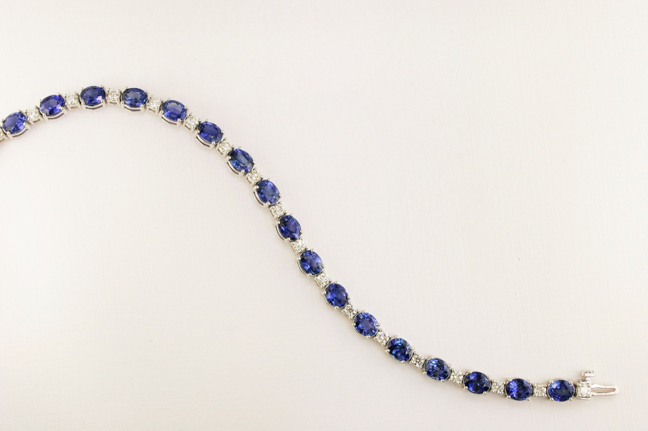 Delicate white gold line bracelet set with blue sapphires