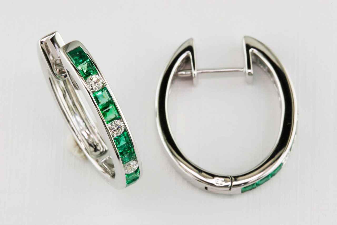 White gold hoop earrings with channel-set emeralds