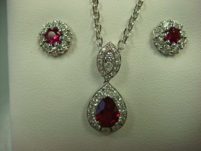 Matching ruby halo stud earrings and pear ruby pendant with diamonds