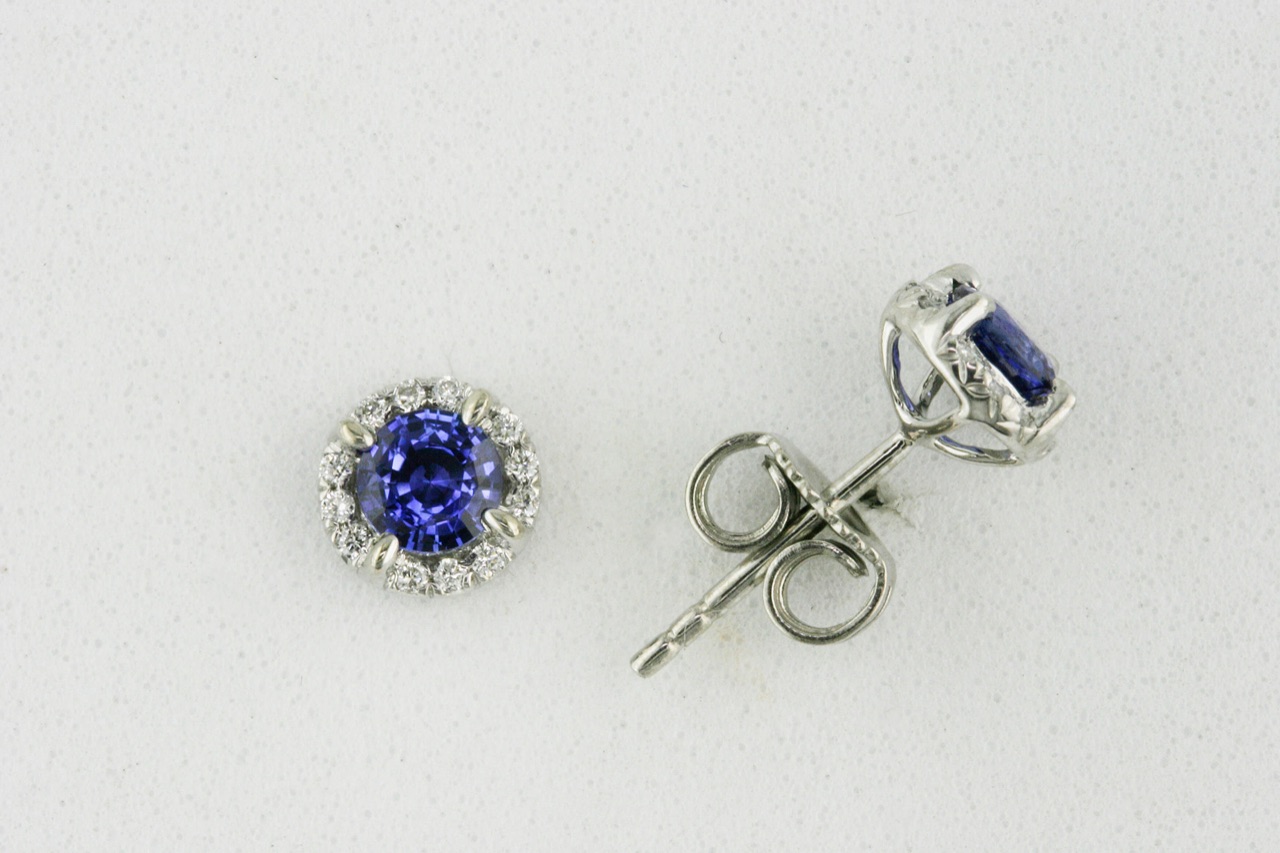 Round blue sapphire stud earrings with diamond halos