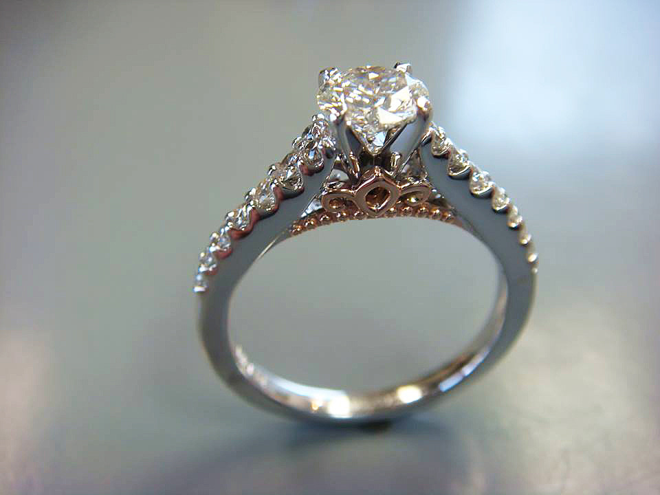 White gold diamond solitaire with a gold filigree basket