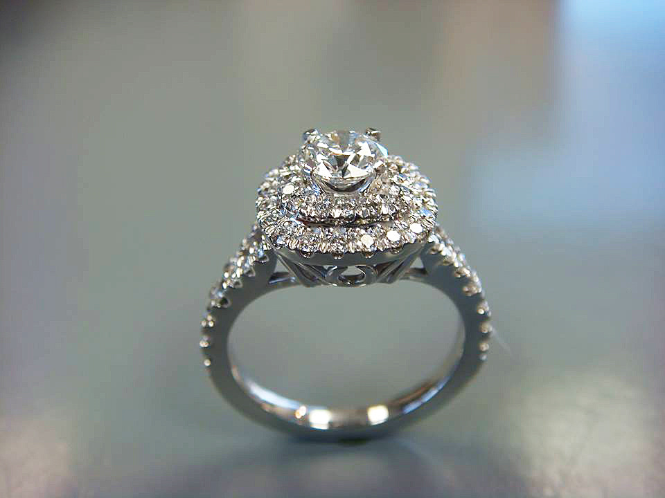 White gold double halo engagement ring with a round center diamond