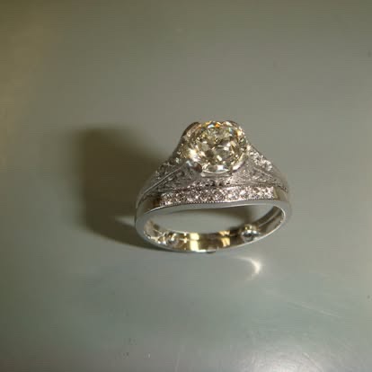 Gold engagement ring with a champagne diamond and pavé band