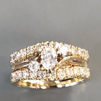 Gold oval diamond engagement ring with two diamond bands