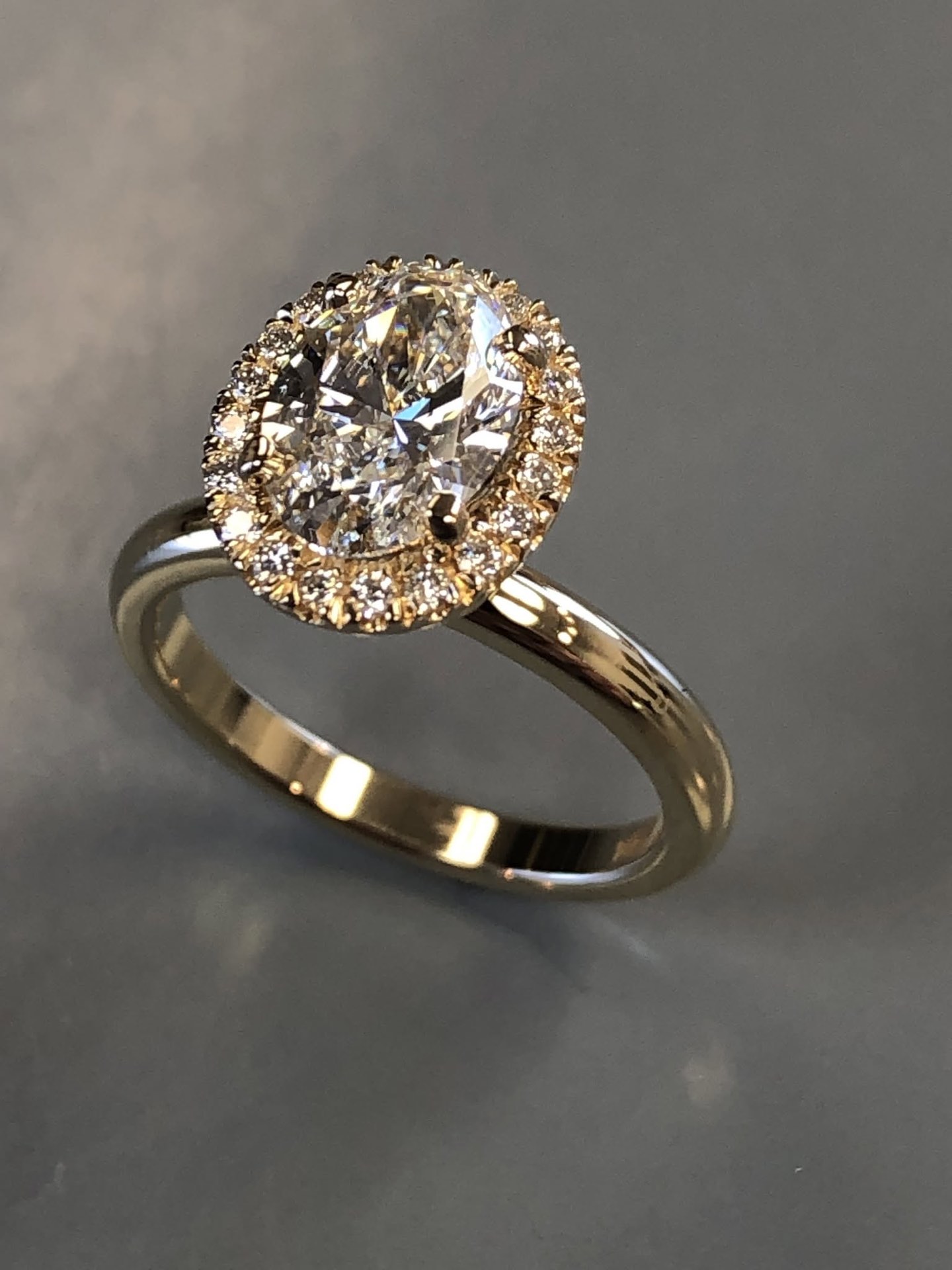 Gold oval diamond halo engagement ring