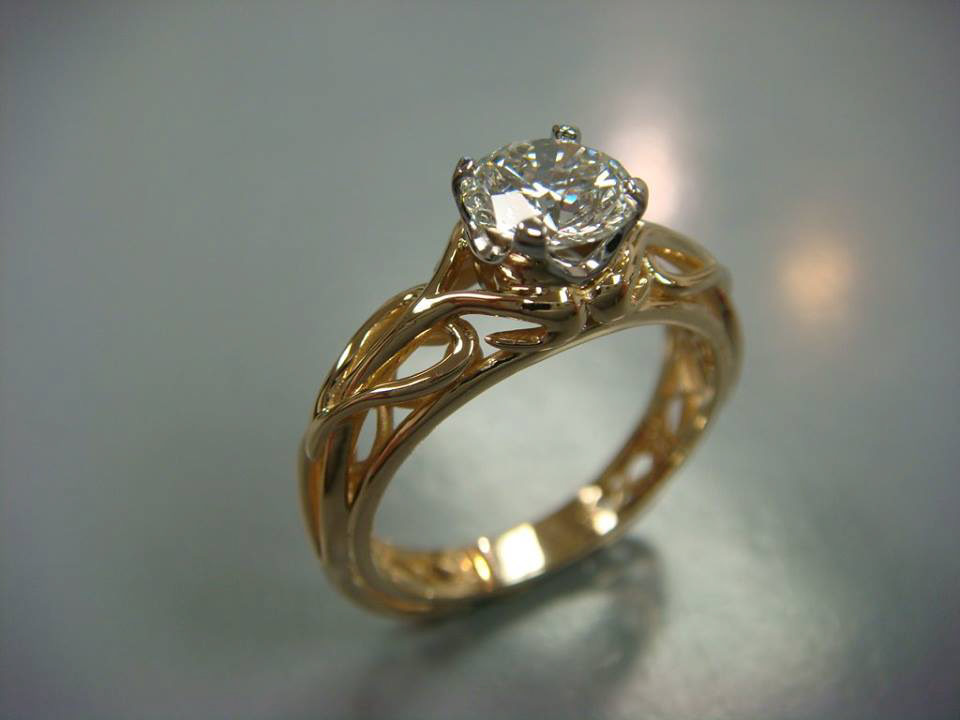 Gold diamond solitaire with a hand-pierced scrollwork band