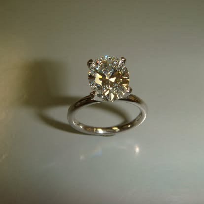 Gold solitaire with a champagne-colored diamond