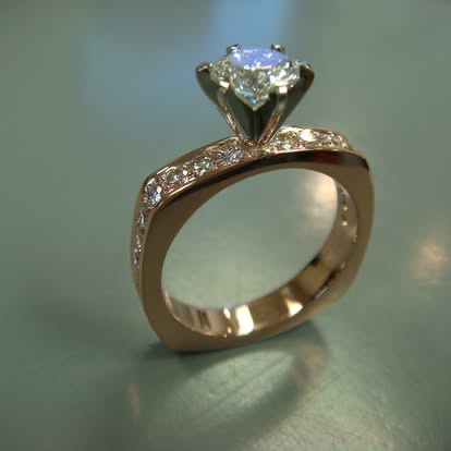 Modern diamond solitaire with a squared gold and white gold shank