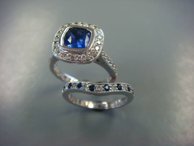 Blue sapphire cushion halo engagement ring paired with a sapphire-accented contour band