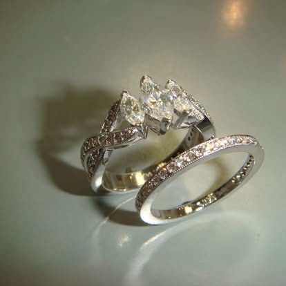 Two-tone engagement ring with marquise side diamonds and a matching band