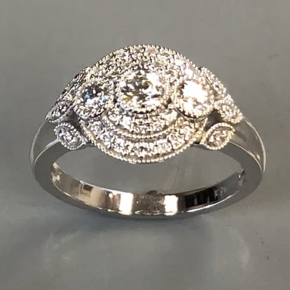 Vintage-style white gold diamond halo ring