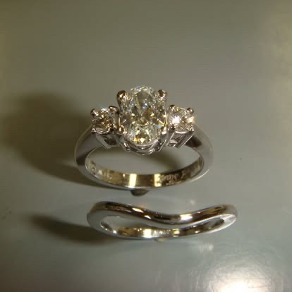 White gold diamond engagement ring with a contour wedding band