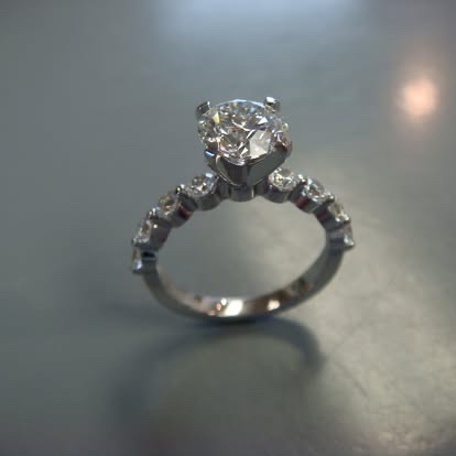 White gold diamond solitaire with graduated diamonds along the band
