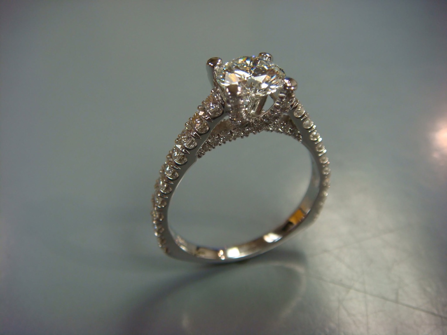 White gold diamond solitaire with pavé-set shoulders