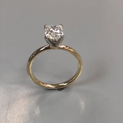 Yellow gold diamond solitaire with a white gold four-prong head