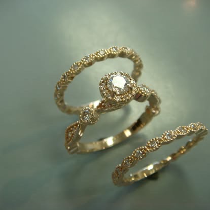 Yellow gold halo engagement ring with two matching milgrain bands