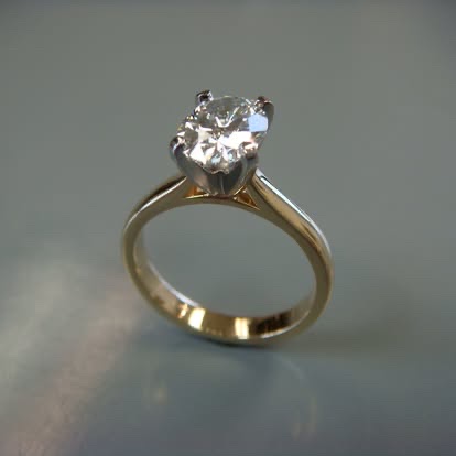 Yellow gold round diamond solitaire in a cathedral setting