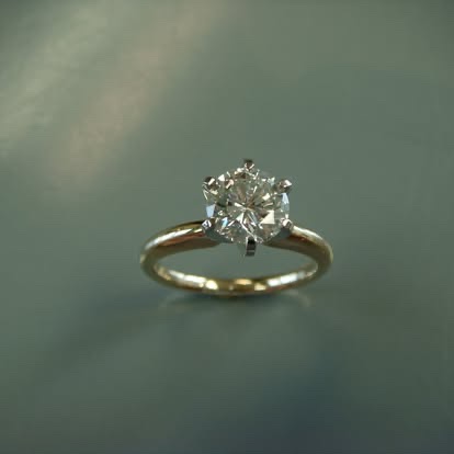 Yellow gold round diamond solitaire with a six-prong setting