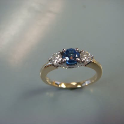 Blue gemstone three-stone ring in yellow gold