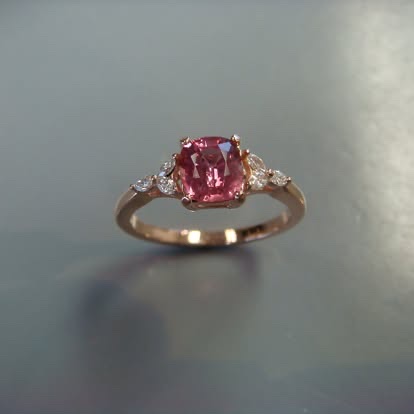 Cushion pink gemstone ring with diamond sides in gold