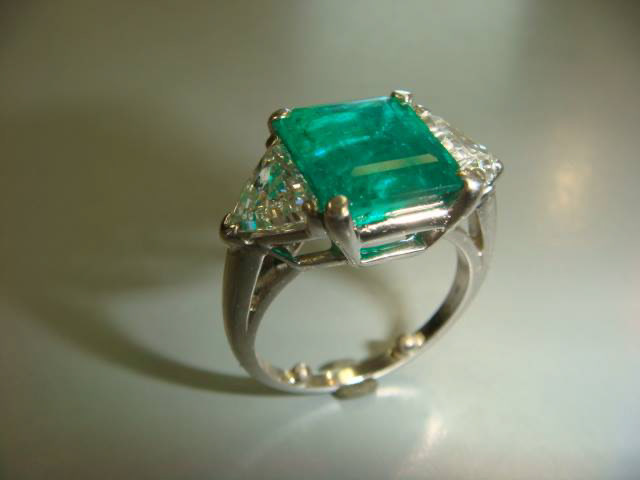 Emerald-cut emerald with trillion diamonds in white gold