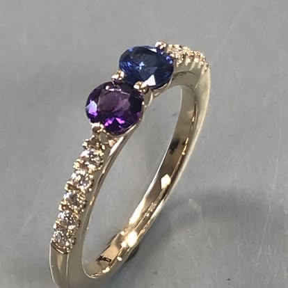 Gold ring with a sapphire, an amethyst and a diamond-set band