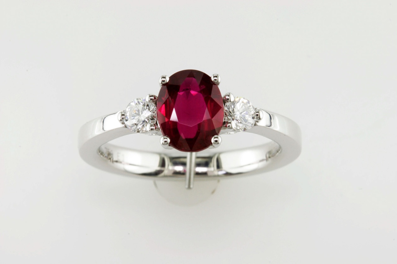 Oval ruby and diamond three-stone ring in white gold