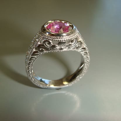 Vintage-style white gold filigree ring with a pink gemstone