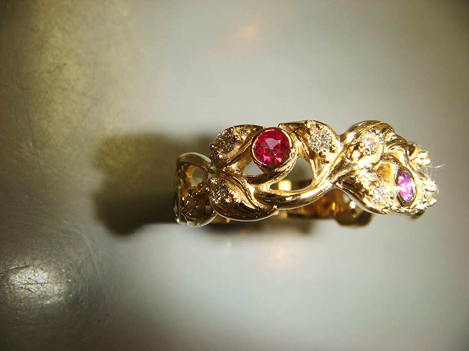 Hand-sculpted floral yellow gold ring with a ruby and a pink gemstone