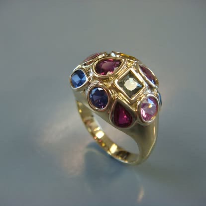 Gold dome ring set with sapphires, rubies and colored gemstones