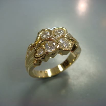 Gold ring with a cluster of bezel-set diamonds