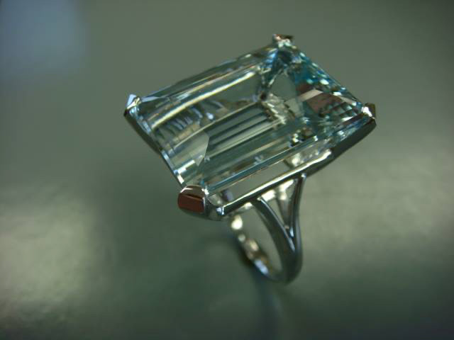 Large emerald-cut light blue gemstone cocktail ring