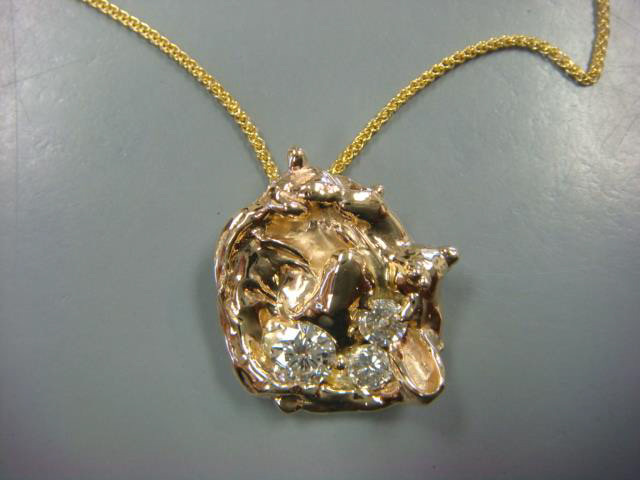 Sculptural yellow gold pendant with scattered diamonds