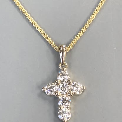 Diamond cross pendant on a yellow gold chain
