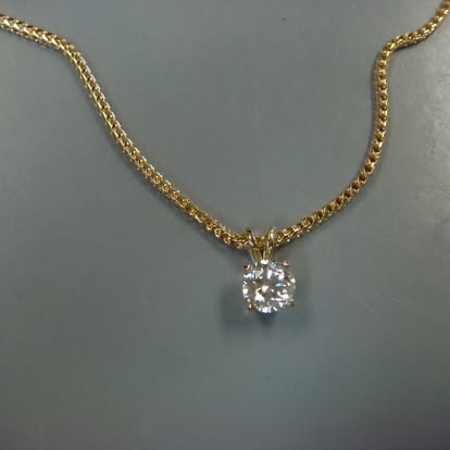 Diamond solitaire necklace on a yellow gold chain