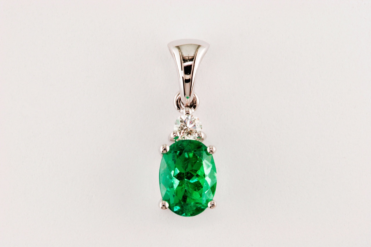 Oval emerald pendant with a diamond accent