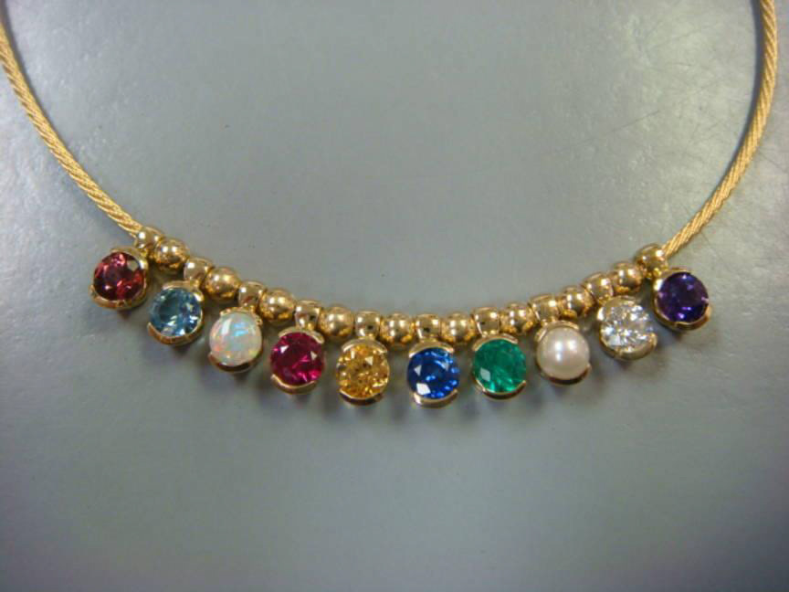 Yellow gold necklace set with a row of colored birthstones