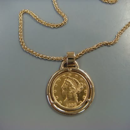 Gold coin pendant on a yellow gold chain