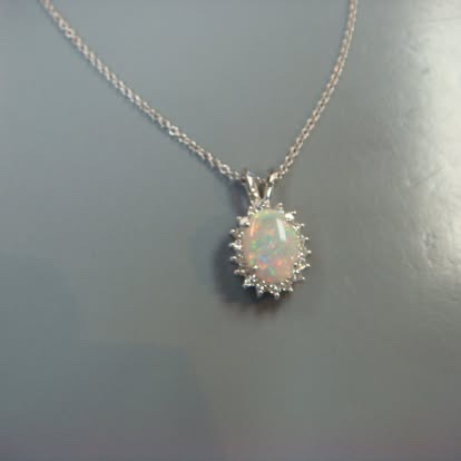 Opal pendant with a diamond halo in white gold
