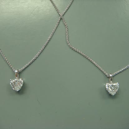Pair of heart-shaped diamond necklaces in white gold