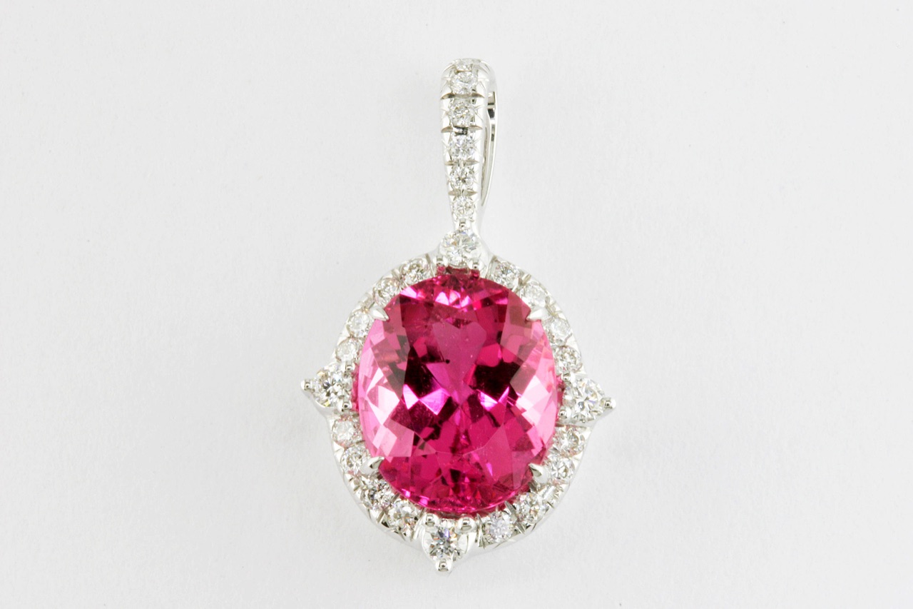 Oval pink gemstone pendant with a diamond halo and pavé bail