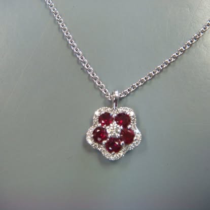 Ruby flower pendant in white gold