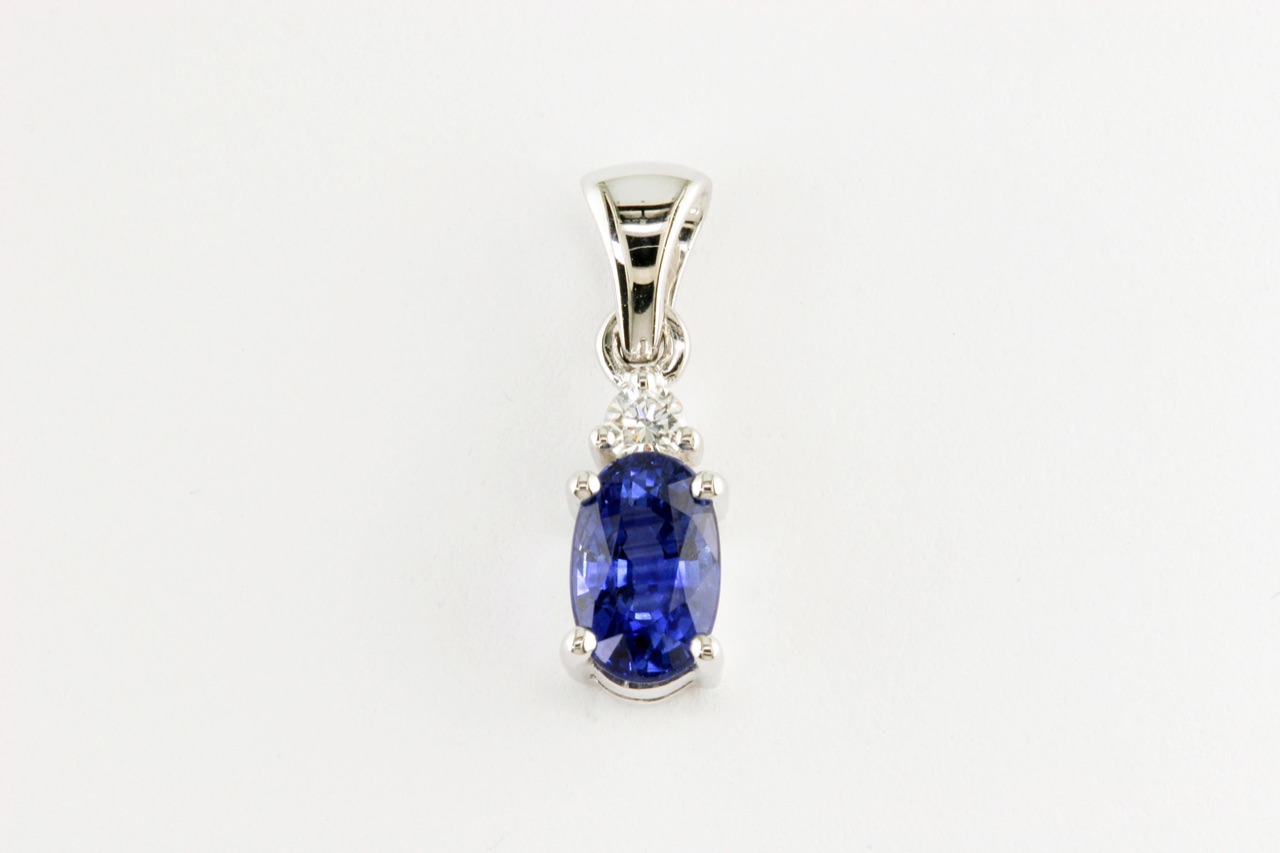 Oval blue sapphire drop pendant with a diamond bail in white gold