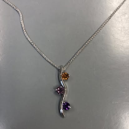 White gold vine pendant with orange and purple gemstones
