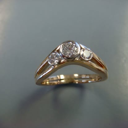 Gold chevron band with bezel-set diamonds