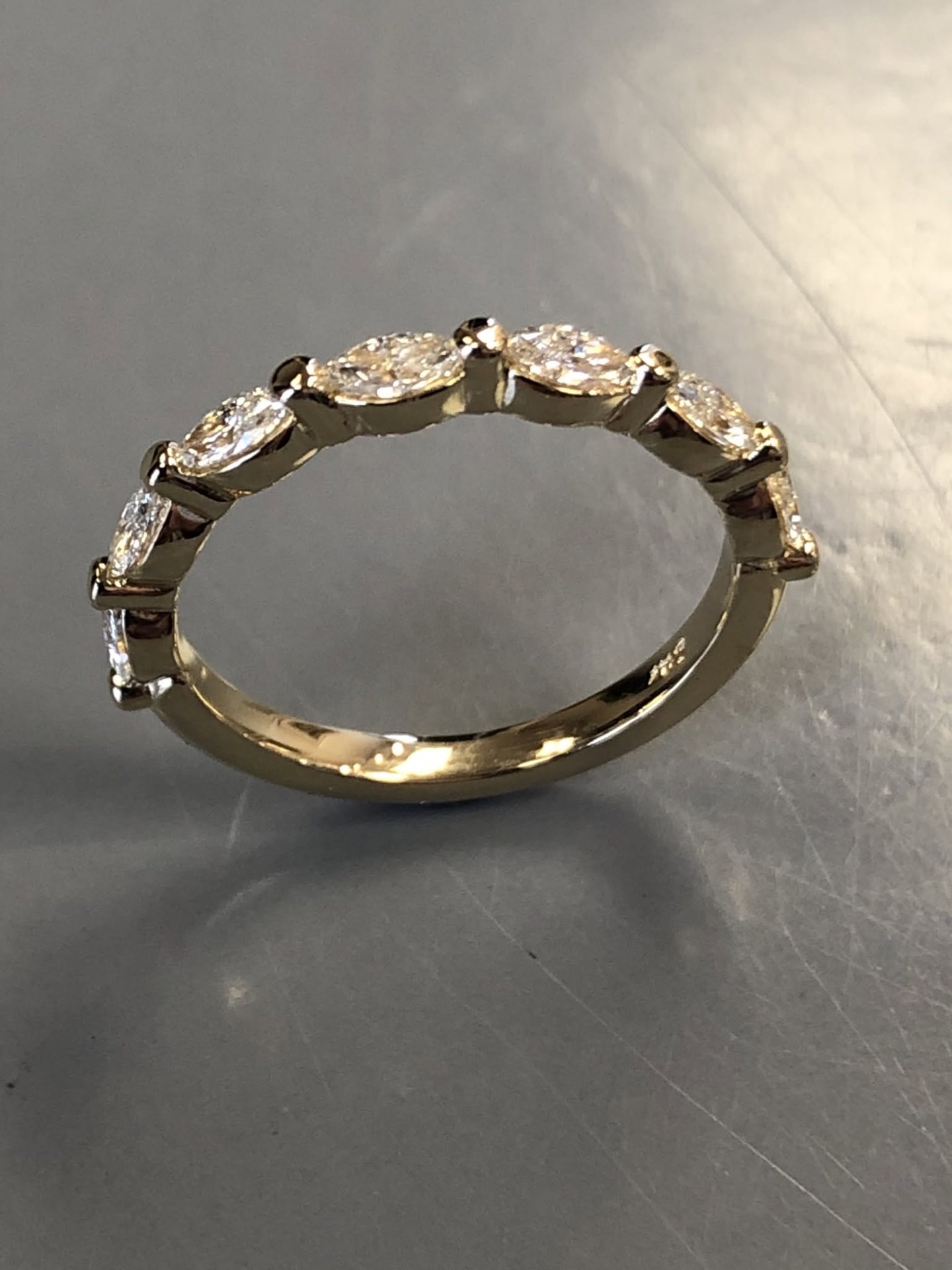 Gold band set with east-west marquise diamonds