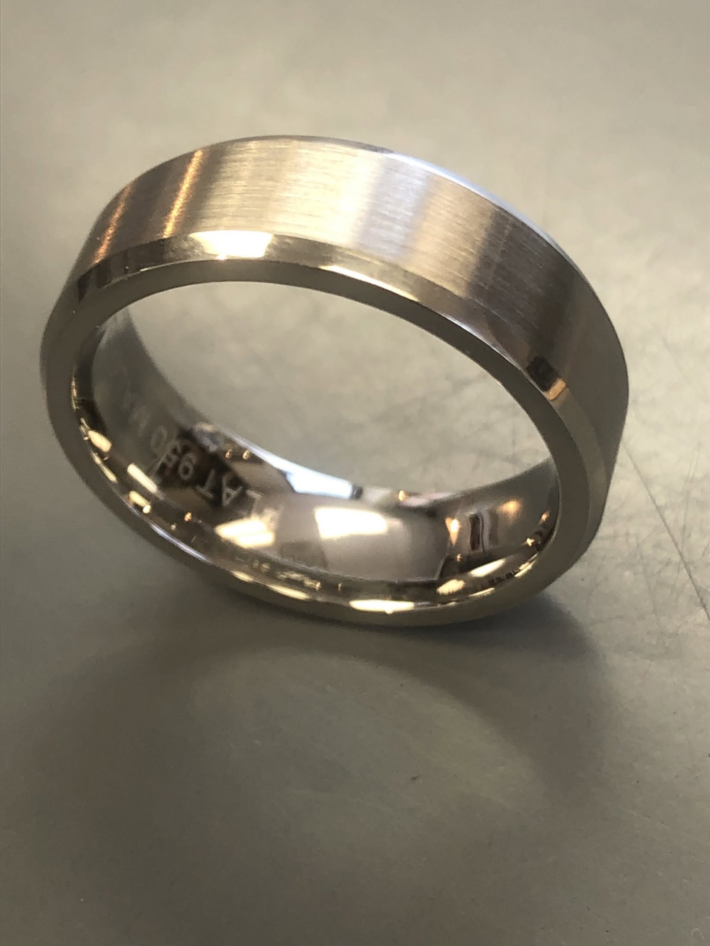 Men's brushed white gold wedding band with polished edges