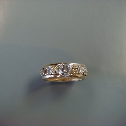 Slim gold band with a row of diamonds