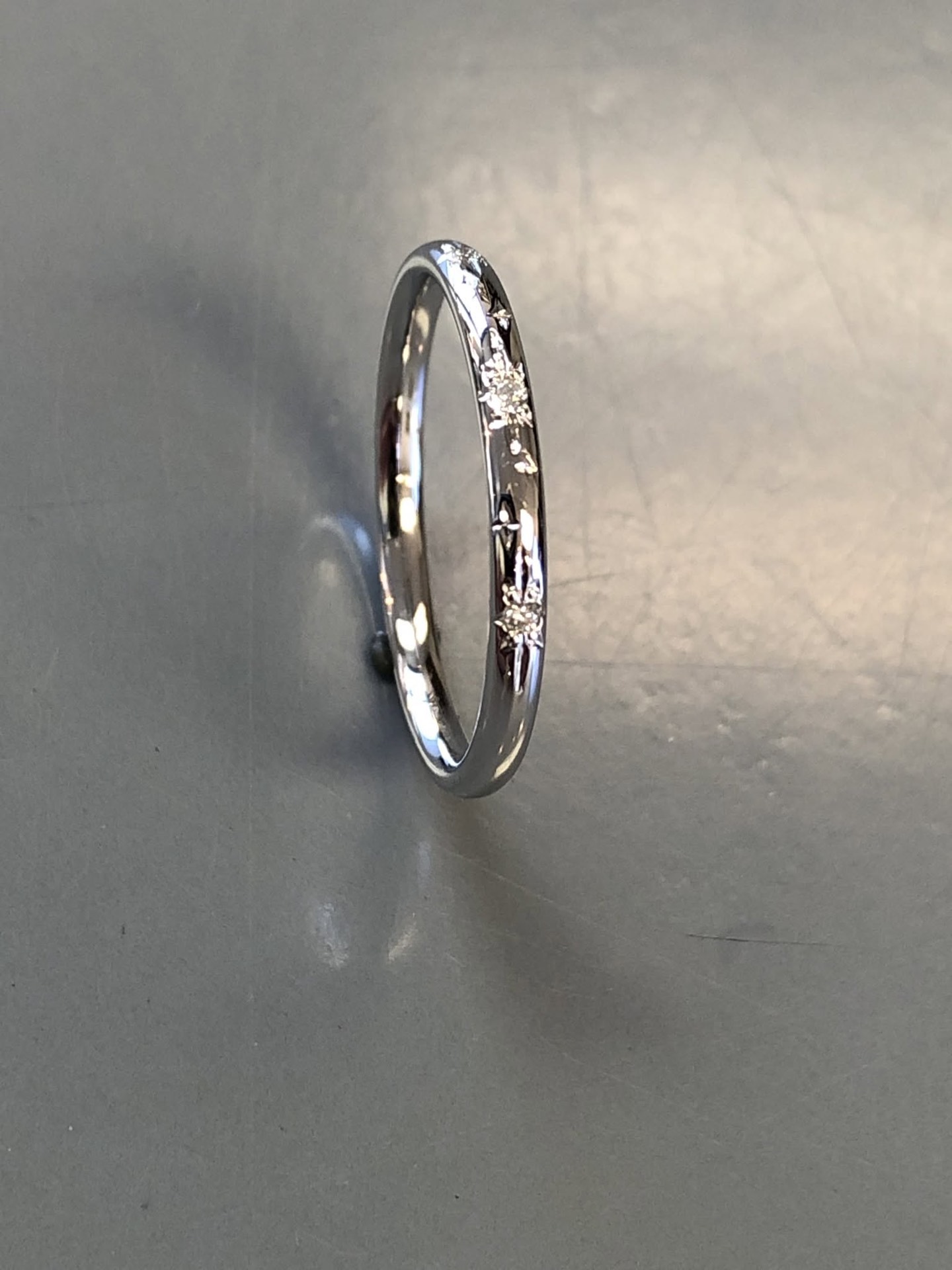Slim white gold band with scattered diamonds